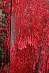 Old shed door detail showing flaking red paint