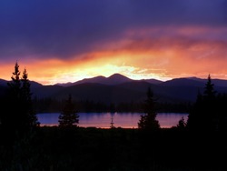 An awesomely colorful sunset reflected in Echo Lake, near the base of Mt. Evans, Colorado.