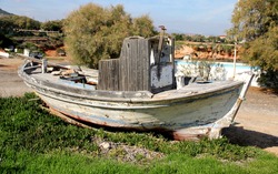 View on the old boat on the beach . Mediterranean. Greece