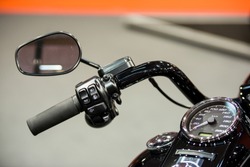 Modern motorcycle speedometer on dashboard and handlebar commands for cruise control, horn and lights