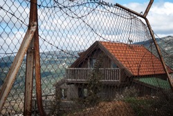 Barbed wire on fence of a private area around Israeli settlements on Golan heights, Israel. Protective fencing of specially protected object of barbed wire. Stamped barbed wire.