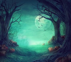 Halloween background. Spooky forest with dead trees and pumpkins.Halloween design with pumpkins