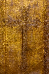 Detail on the golden plated door on the church door.