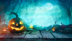Halloween Pumpkins on wood. Halloween Background At Night Forest with Moon.