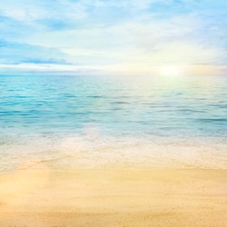 Beautiful sea summer or spring abstract background. Golden sand beach with blue ocean and cloudscape and sunset in the back.