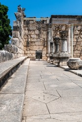 Reconstruction of the ruins of the White Synagogue where Jesus preached at Capernaum, Kfar Nahum, Capharnaum, next to the Sea of Galilee in Israel. Seating area on the sides of the synagogue.
