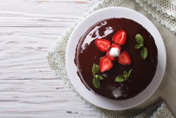 Chocolate cake with fresh strawberries on a table. horizontal view from above