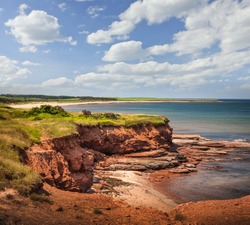 Red cliffs of Prince Edward Island Atlantic coast at East Point, PEI, Canada.