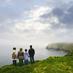 Family looking from cliff at Cape St. Mary's Ecological Bird Sanctuary in Newfoundland, Canada