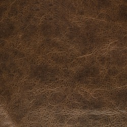 Closeup detail on old brown leather texture background.