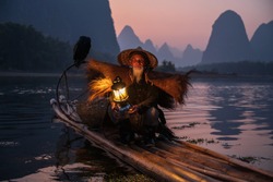 An old fisherman with a lamp on a raft