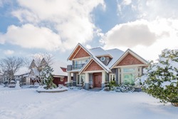 A typical american house in winter. Snow covered.