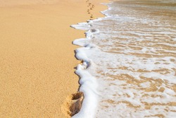Footprints on the beautiful ocean sand. Set of six pictures showing ocean waves in different stages over footprints. Cabo San Lucas. Mexico.