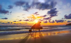 Music background.Melody and song concept in nature.Surreal image of grand piano in scenic sunset beach