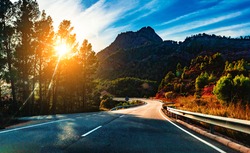 Car travelling and scenic desert road.Adventures and destination concept.Country road background and colorful sunset landscape.