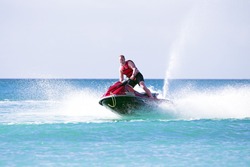 Young guy cruising on the atlantic ocean on a jet ski