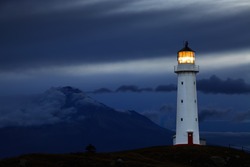 Cape Egmont Lighthouse and Taranaki Mount on background, New Zealand