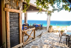 A Taverna in Ios, Greece with the chalk menu-board outside.