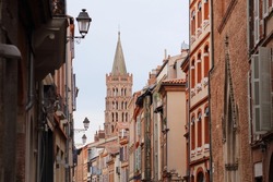Street in Toulouse city, France. Basilica Saint Sernin in background.