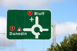 Road directions in New Zealand. Traffic sign in Invercargill with directions to Bluff and Dunedin.