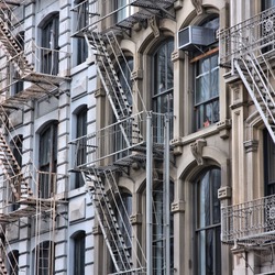 New York City, United States - old residential buildings in Soho district. Fire escape stairs.