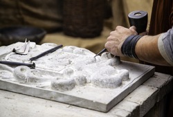 Carving stone in a traditional way, craftsmanship detail, shaping the stone