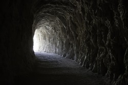 Deep stone tunnel, detail of ancient cave on a mountain