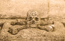 Stone skull, detail of an ancient cemetery, death