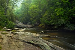 Beautiful Appalachian Mountain forest in North Carolina, with a rocky river cutting through the woods in early morning (Chattooga River and Nantahala National Forest)