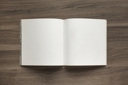Photo blank. Open square format brochure on a wooden table