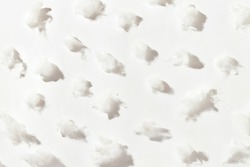 Pattern made of modern bio-polymeric synthetic filler for fabric toys on on white background. White synthetic fabrics