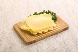 Sliced Gouda cheese snack over board