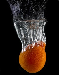 orange dropped in fish tank filled with water