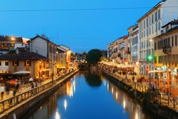 Naviglio Grande canal night life with restaurant and bars in Milan, Italy.