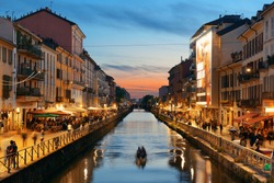 Naviglio Grande canal night life after sunset with restaurant and bars in Milan, Italy.