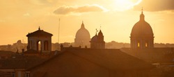 Rome rooftop view at sunset panorama with ancient architecture in Italy. 