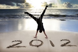 happy new year 2012 on the beach with sunrise background