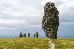 Manpupuner rock formations. Weathered stone pillars. Famous nature landmark of Ural mountains, Komi Republic, Russia. Travel destination landscape.