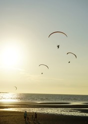 Silhouette of para gliding at sunset sky with sea background