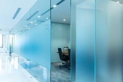 Large translucent glass blocks the meeting room, neat chairs, notice boards, poster materials