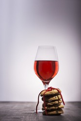 Crispy cookies with glass of wine on wooden table