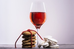 Glass of red wine with cookies and macaroons