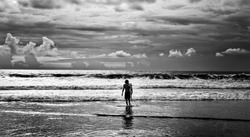 Men surfer and ocean. Black-white fine art photo.