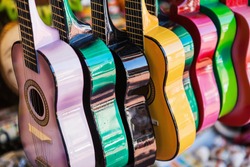 Background of colorful traditional small mexican guitars