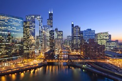 City of Chicago. Image of Chicago downtown and Chicago River with bridges during sunset.