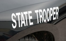 White state trooper -decal on a black law enforcement vehicle