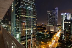 Night cityscape view of the Brickell Avenue area in downtown Miami with office buildings and skyscraper condominiums.