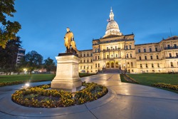 Lansing, Michigan, USA at the Michigan State Capitol during the evening. (Governor Austin Blair statue dedicated in 1898)