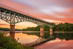 Augusta, Maine, USA view on the Kennebec River with Memorial Bridge at dawn.