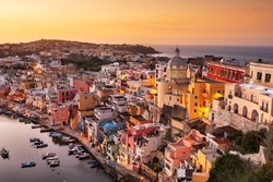 Procida, Italy old town skyline in the Mediterranean Sea during dusk.